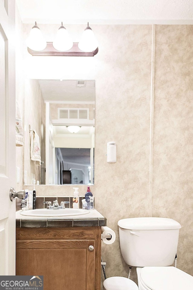 bathroom with vanity and toilet