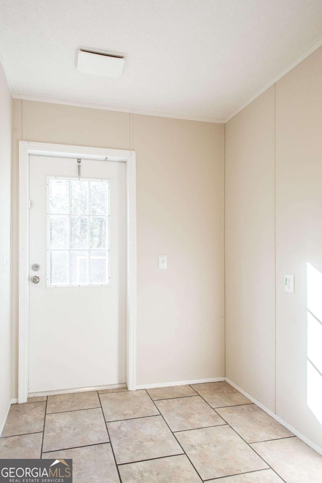 interior space with light tile patterned floors and a textured ceiling