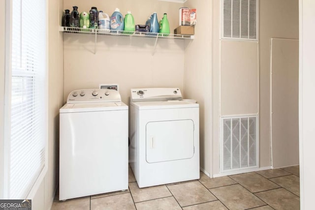 laundry room featuring independent washer and dryer and light tile patterned floors