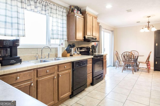 kitchen with sink, an inviting chandelier, crown molding, decorative light fixtures, and black appliances