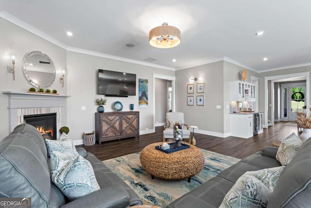 living room featuring crown molding, dark hardwood / wood-style flooring, beverage cooler, and a brick fireplace