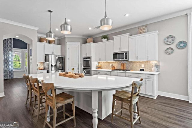 kitchen featuring backsplash, a spacious island, decorative light fixtures, white cabinetry, and stainless steel appliances