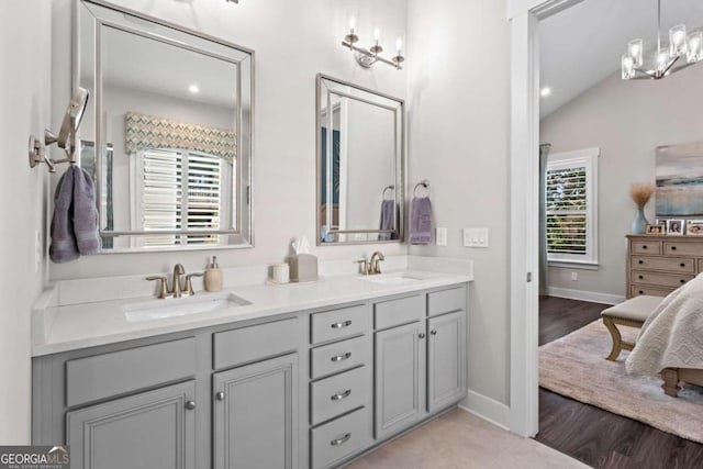 bathroom featuring vanity and lofted ceiling