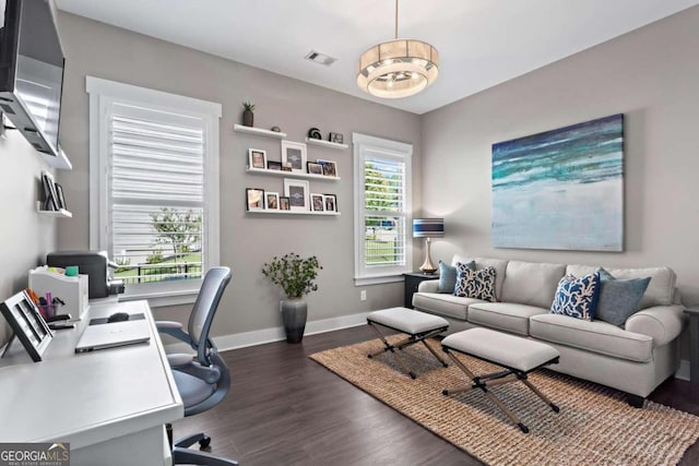 office space featuring a chandelier, dark hardwood / wood-style flooring, and plenty of natural light