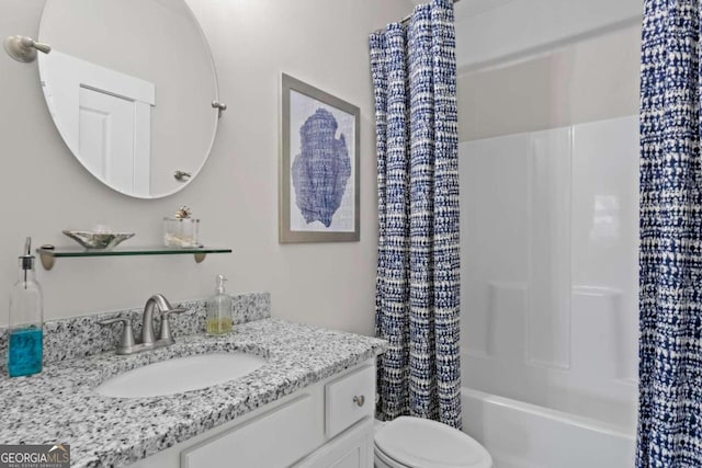 full bathroom featuring toilet, vanity, and shower / tub combo with curtain