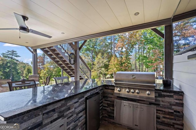 view of patio / terrace with exterior bar, exterior kitchen, and a grill