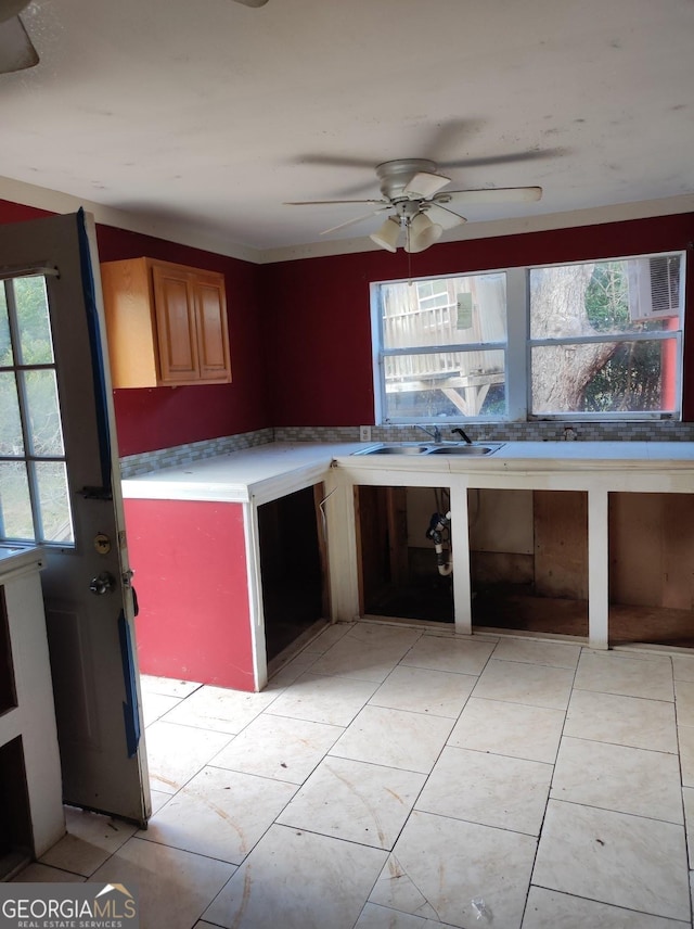 kitchen featuring ceiling fan and sink