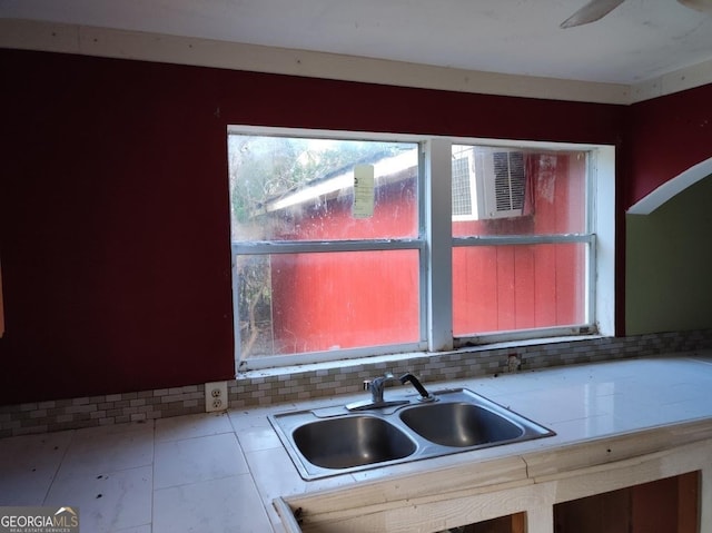 kitchen featuring decorative backsplash and sink