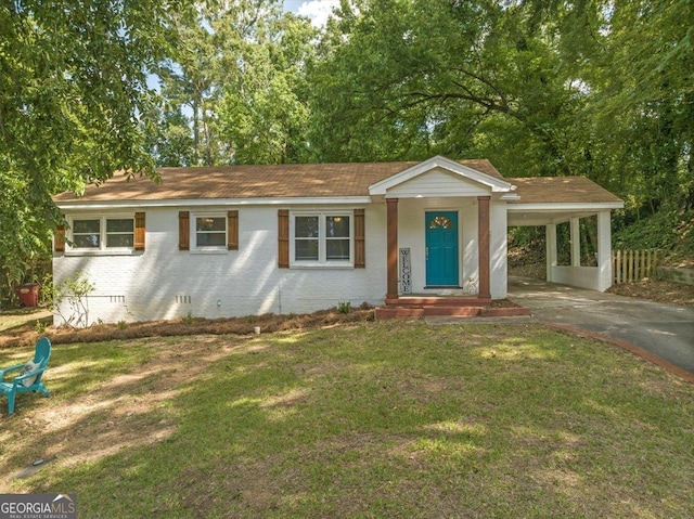 ranch-style house featuring a front yard and a carport