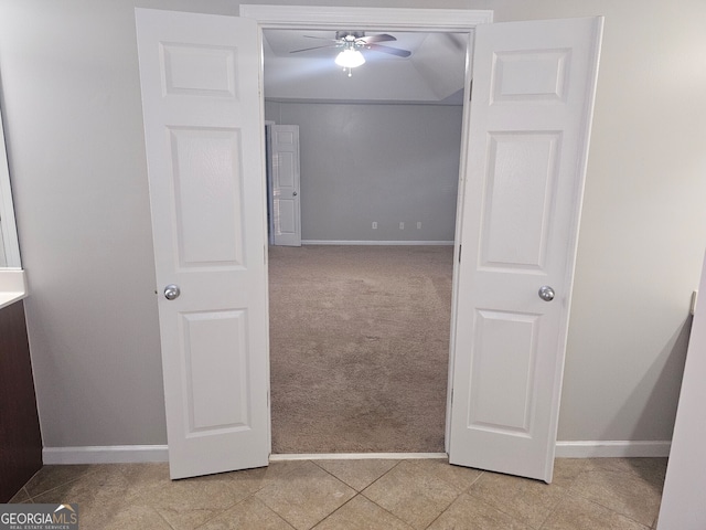 interior space with ceiling fan