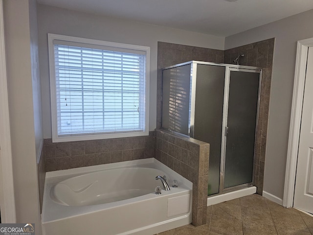 bathroom with tile patterned floors and independent shower and bath