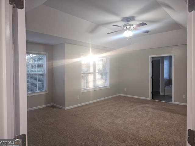 carpeted spare room featuring ceiling fan and vaulted ceiling