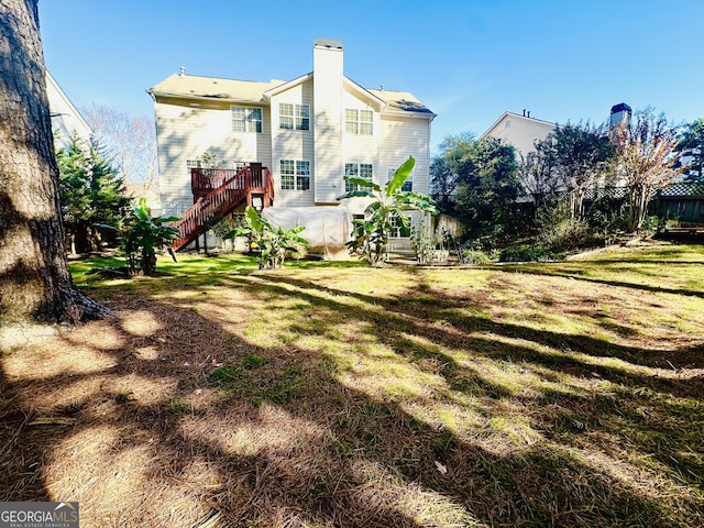 rear view of house with a yard