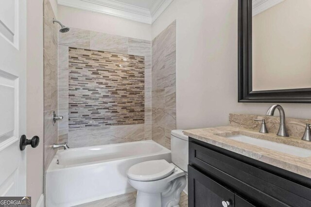 full bathroom with vanity, toilet, crown molding, and tiled shower / bath