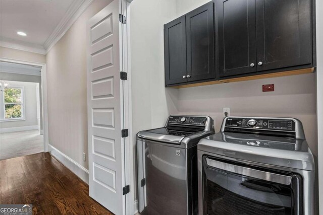 laundry area with cabinets, separate washer and dryer, dark hardwood / wood-style floors, and ornamental molding