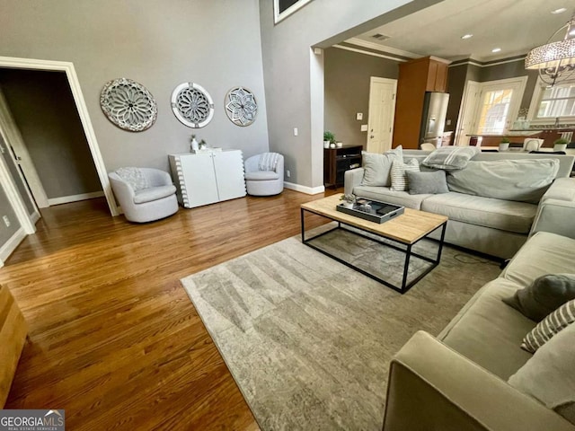 living room with hardwood / wood-style floors and an inviting chandelier