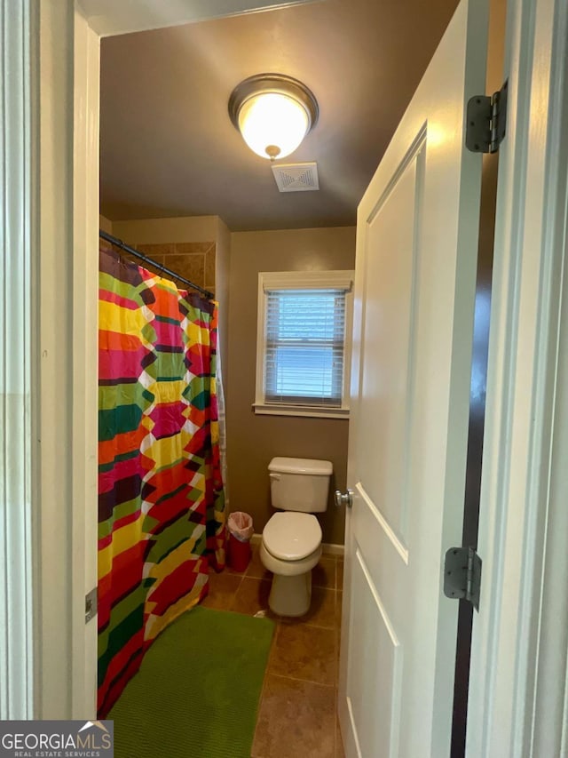 bathroom featuring tile patterned floors and toilet