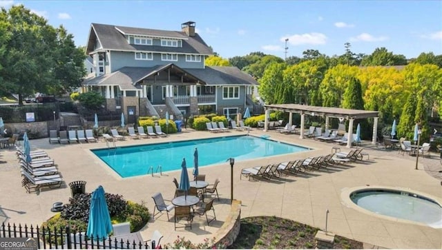 view of swimming pool featuring a community hot tub and a patio