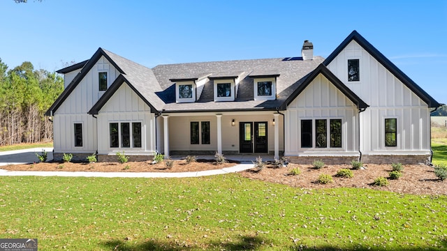 view of front of home with a front yard and french doors