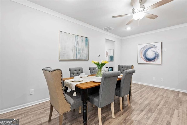 dining room featuring ceiling fan, light hardwood / wood-style flooring, and ornamental molding