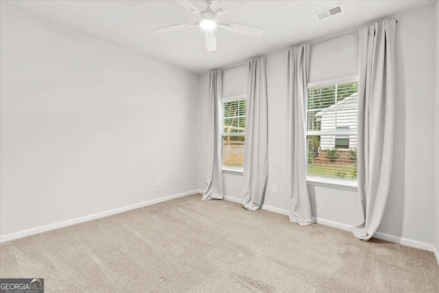 unfurnished room with light carpet and ceiling fan