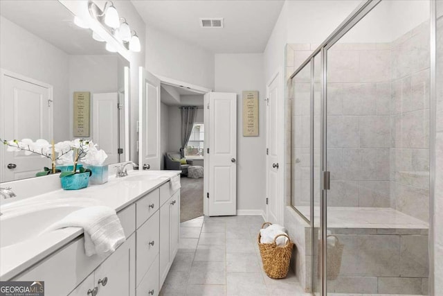 bathroom with vanity, tile patterned floors, and walk in shower