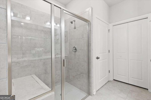 bathroom with a shower with door