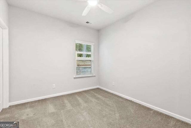 carpeted spare room with ceiling fan