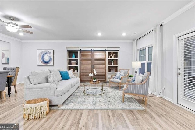 living room with light hardwood / wood-style flooring, ceiling fan, and crown molding