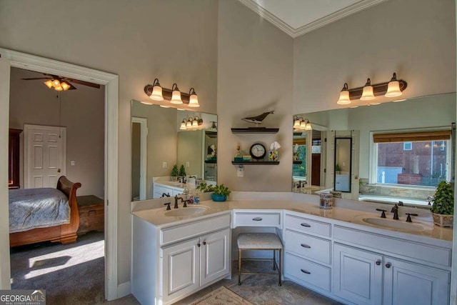 bathroom featuring ceiling fan, vanity, and ornamental molding