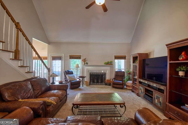 carpeted living room featuring high vaulted ceiling, a wealth of natural light, and ceiling fan