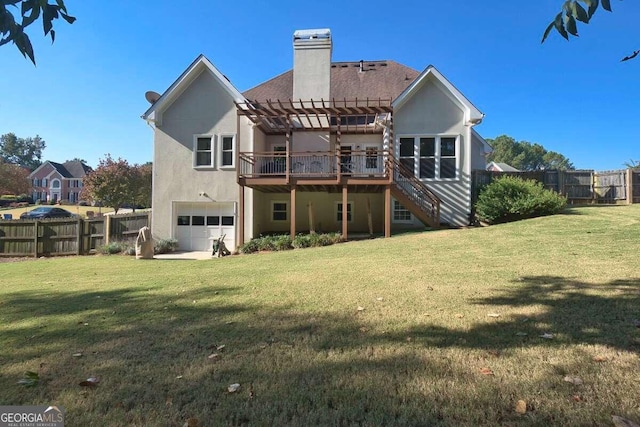 rear view of house featuring a garage, a lawn, and a wooden deck