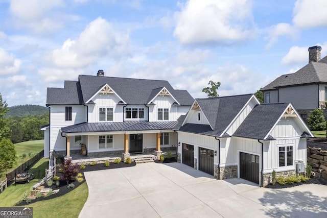 modern inspired farmhouse featuring covered porch and a garage