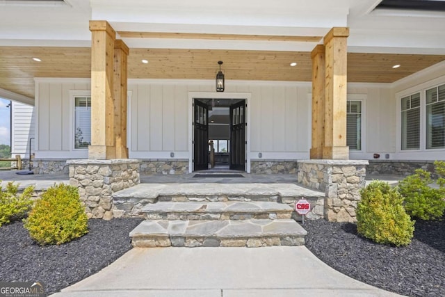 view of exterior entry with a porch