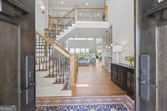 entryway featuring hardwood / wood-style floors and a high ceiling