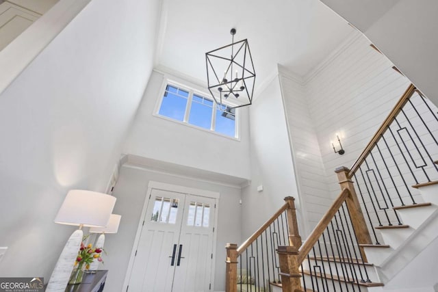 foyer featuring a towering ceiling and an inviting chandelier