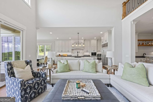 living room with sink and a high ceiling