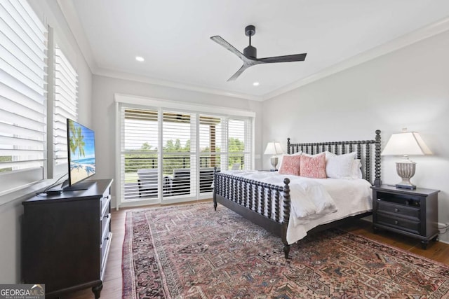 bedroom featuring dark hardwood / wood-style flooring, ceiling fan, and crown molding