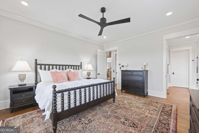 bedroom with ceiling fan, dark hardwood / wood-style flooring, and crown molding