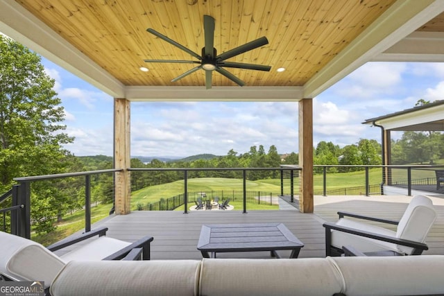 wooden terrace featuring ceiling fan