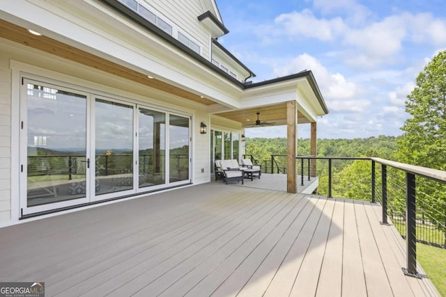 wooden deck with ceiling fan and an outdoor hangout area