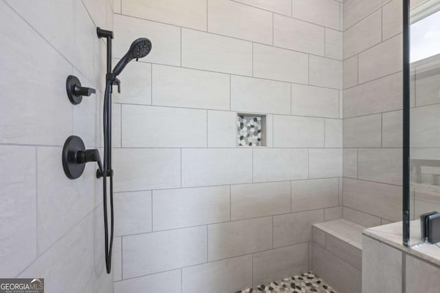 bathroom featuring a tile shower