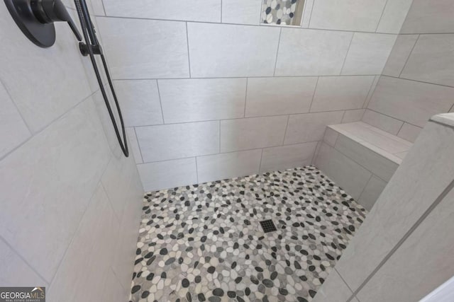 bathroom with tiled shower