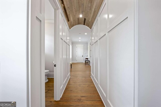 hall featuring hardwood / wood-style floors and wooden ceiling