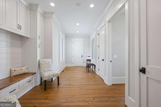 interior space with crown molding and hardwood / wood-style flooring