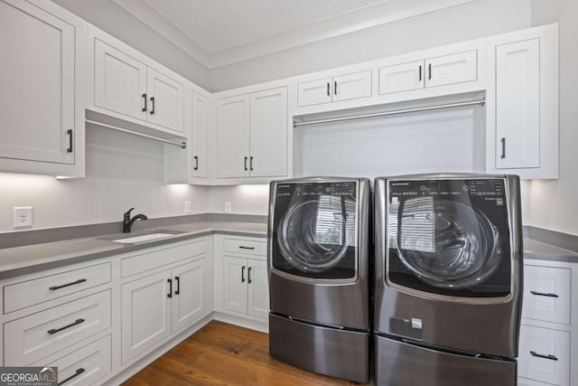 clothes washing area with dark hardwood / wood-style floors, independent washer and dryer, sink, and ornamental molding