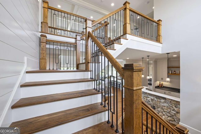 staircase featuring a high ceiling