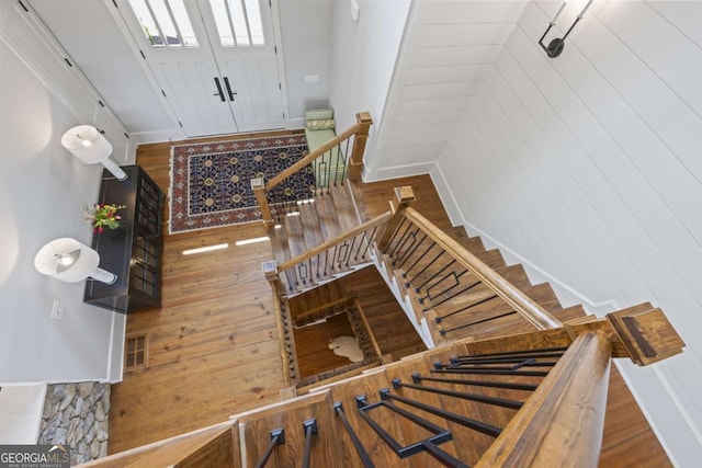 stairway with hardwood / wood-style floors