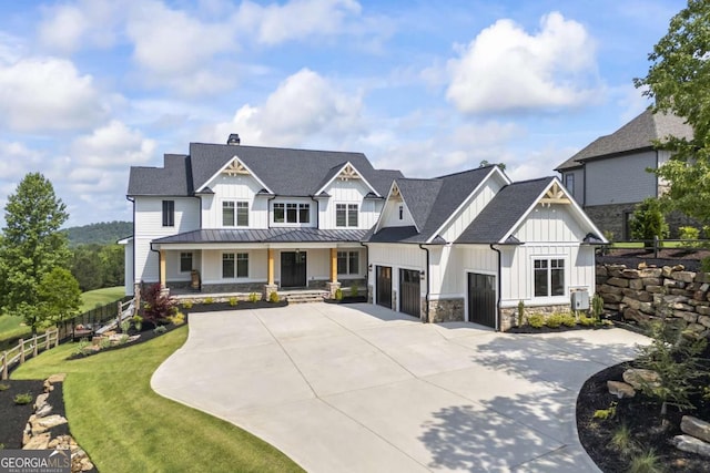 view of front of house with a garage, covered porch, and a front lawn