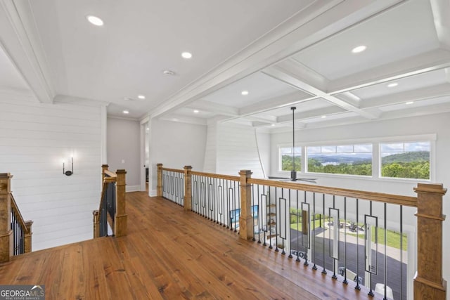 hallway with beam ceiling, ornamental molding, coffered ceiling, and wood-type flooring